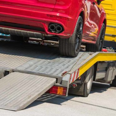 Red Sports Car on Norma Jean Towing Flatbed
